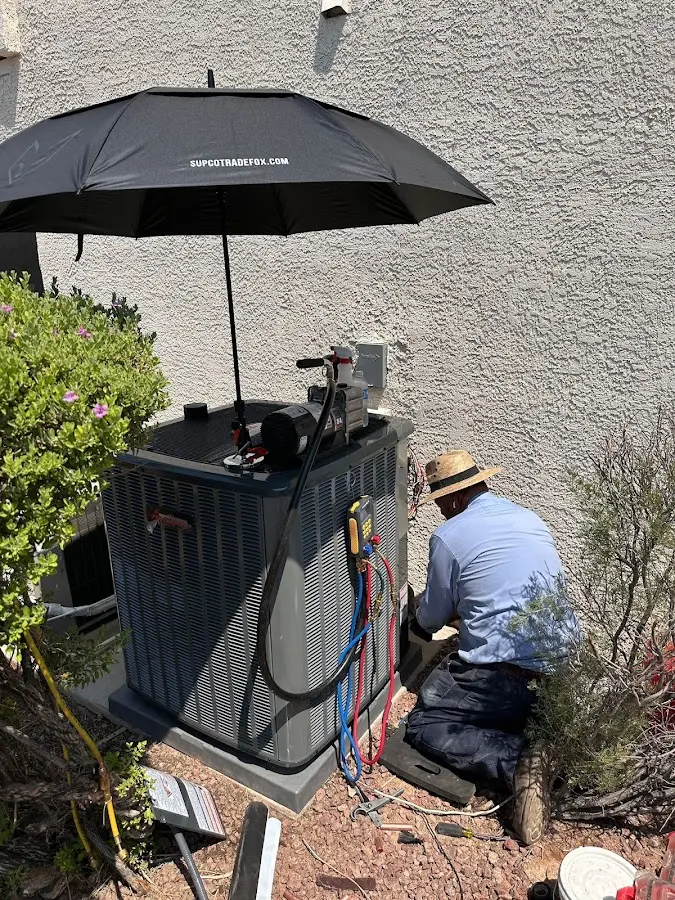 HVAC technician performing outdoor AC maintenance in Bellevue